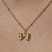 Tilda Bow Earrings & Pendant Necklace Gift Set (Gold)
					