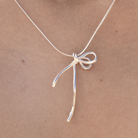 Trini Artisan Bow Tie Pendant Necklace
					