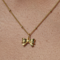 Tilda Artisan Bow Tie Pendant Necklace (Gold)
					