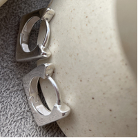 New Frame of Mind Huggie Earrings (Silver)
					