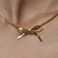 Adria Bow Tie Snake Chain Necklace (Gold)
					