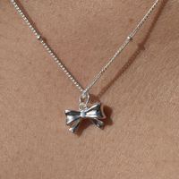 Tilda Artisan Bow Tie Pendant Necklace (Silver)
					